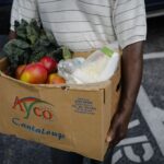 Man carrying box of fresh produce.