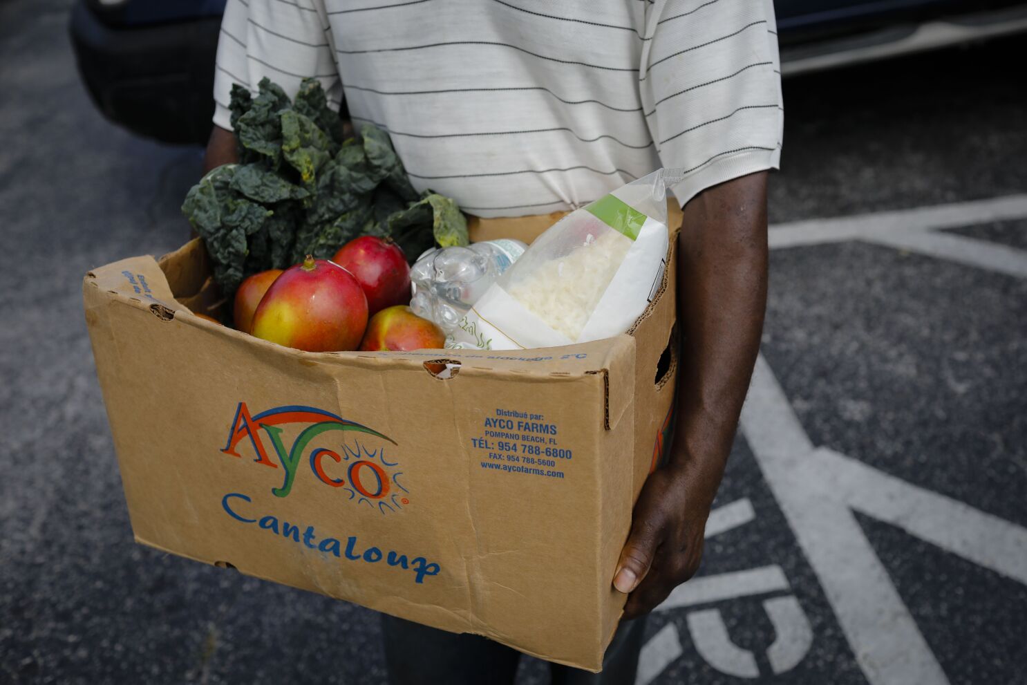 Man carrying box of fresh produce.
