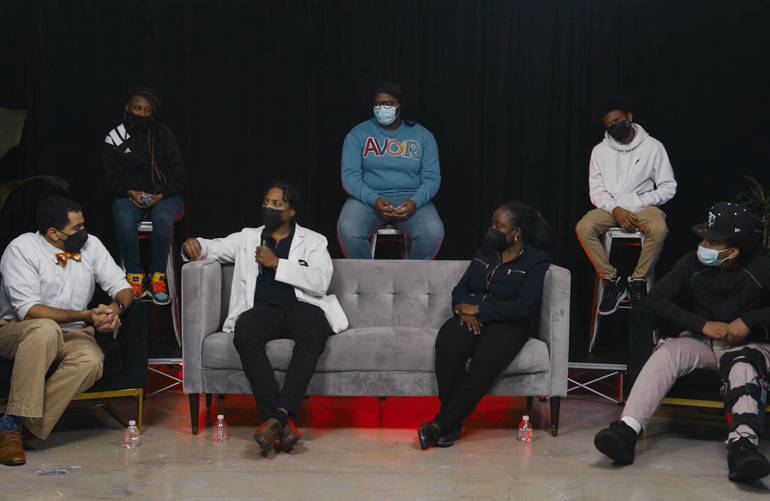 A group of people sitting on top of a couch.