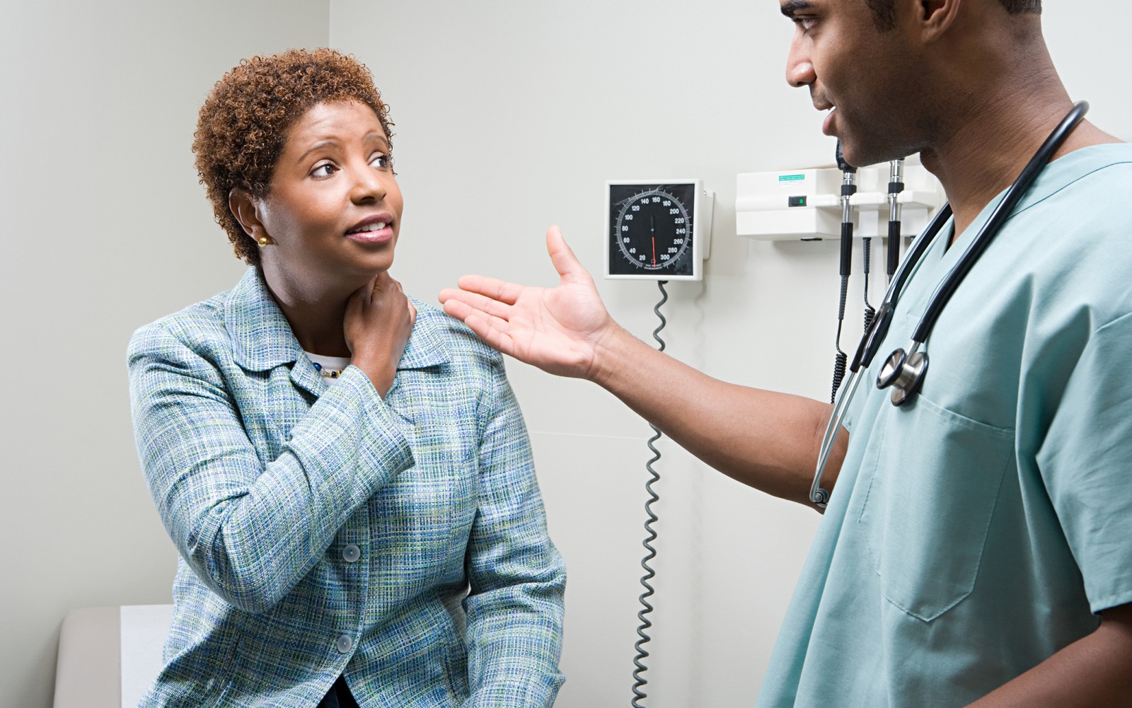 Doctor consulting woman in medical office.