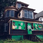 A house with green and white designs on the side of it.