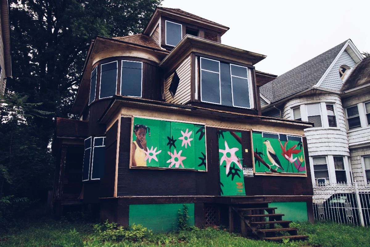 A house with green and white designs on the side of it.