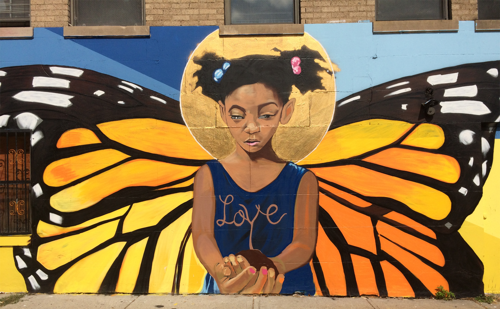 Girl with butterfly wings mural, "Love" written.