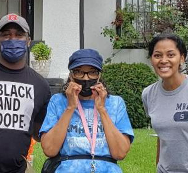 A group of people standing in front of some houses.